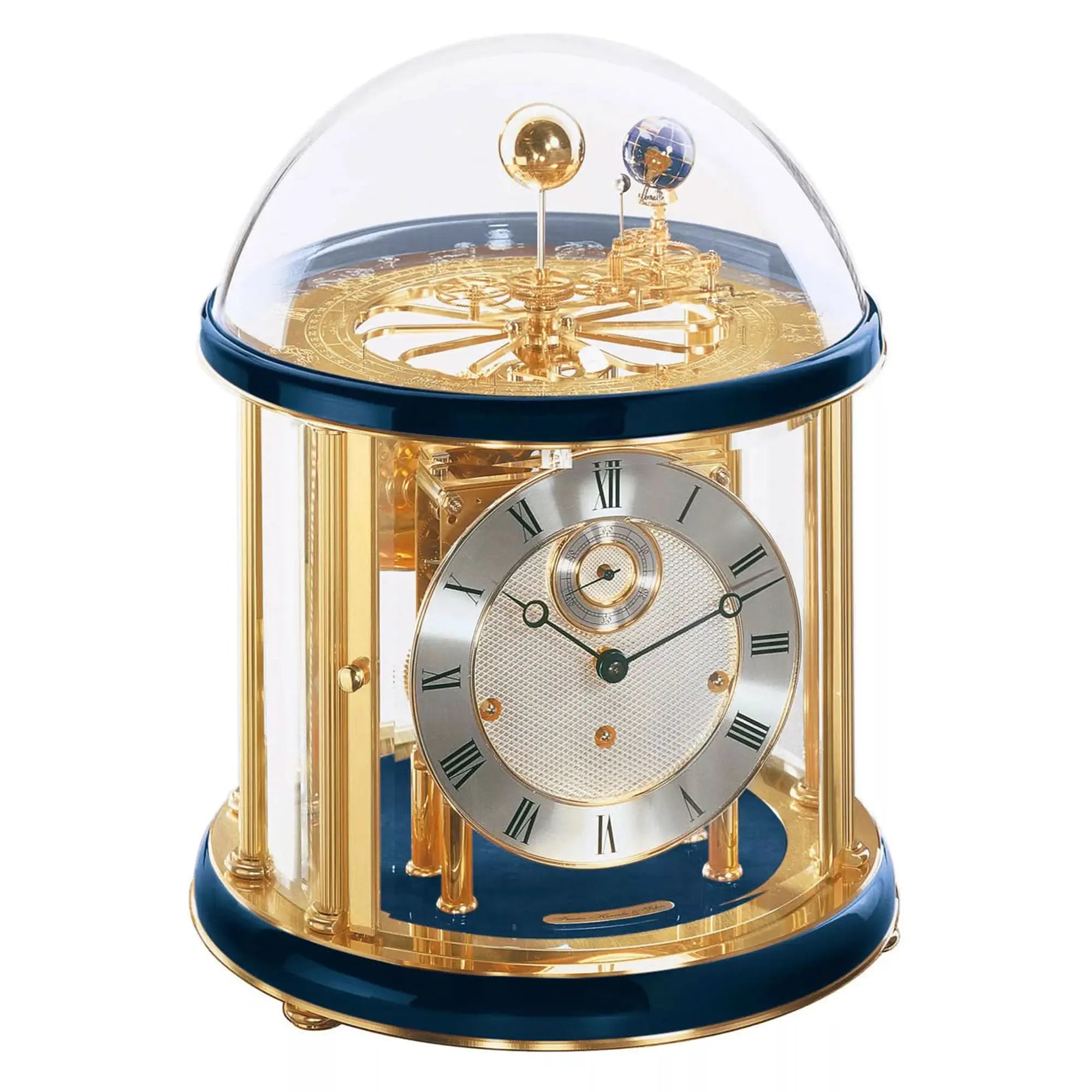 Reloj de mesa mecánico con campana de cristal, estructura dorada y base azul
