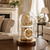 Reloj de mesa con interior dorado bajo campana de cristal, base en marrón oscuro