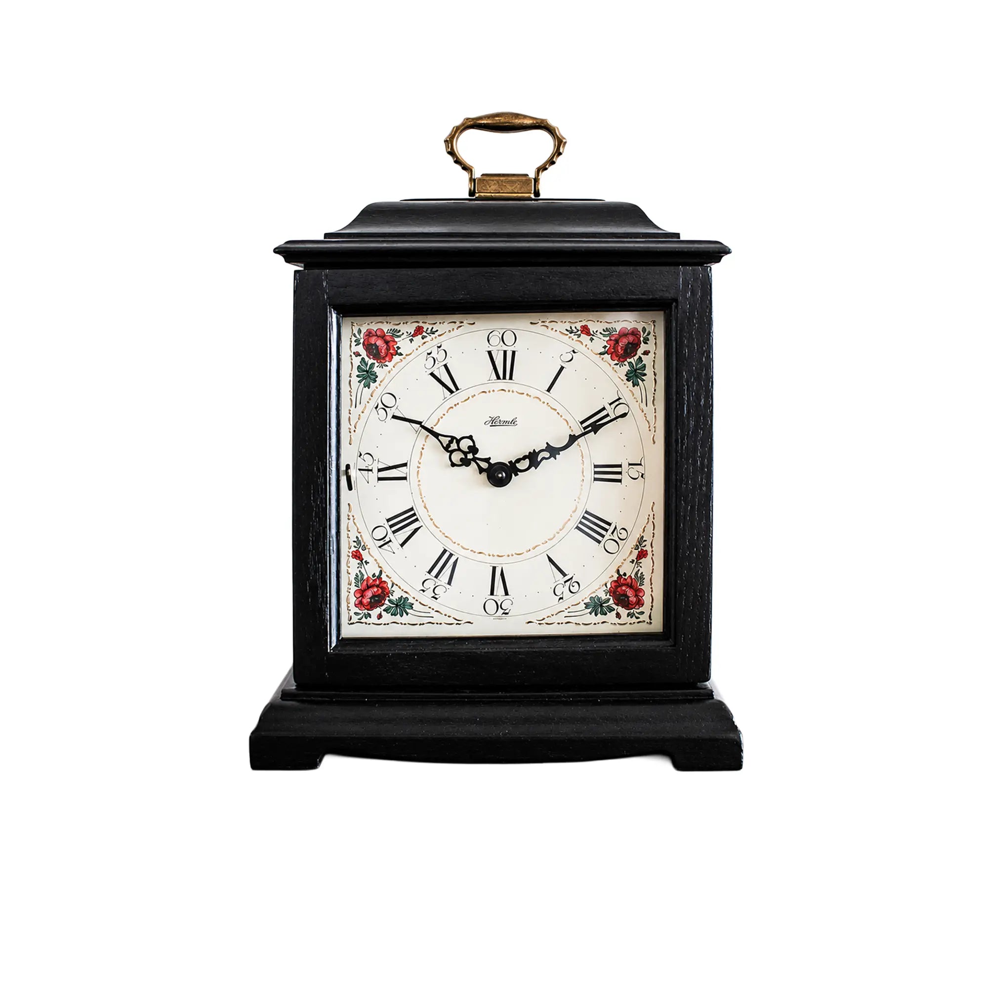 Reloj de mesa negro con carcasa de madera, asa dorada y esfera floral