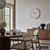 Karlsson Stark Wanduhr in warmgrauem Gehäuse, analoges Zifferblatt mit schwarzen Zeigern.