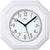 "Reloj de pared blanco con marco octogonal de cerámica, esfera redonda con manecillas negras."
