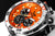 Reloj para hombre con esfera naranja, subesferas negras de cronógrafo y bisel plateado