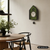 Pendeluhr an der Wand im Hausdesign mit grünem Moos-Einsatz und Kuckuck-Attrappe