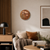 Runde LED-Wanduhr mit braunem Zifferblatt und leuchtender Wortanzeige an der Wand