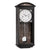 "Reloj de pared con caja de madera oscura, esfera blanca y números romanos, péndulo visible"