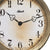 Reloj de pared con marco en color latón, números y manecillas negras, Hermle